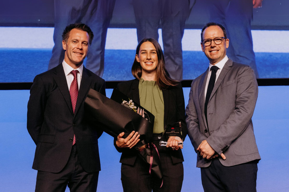 DRLS solicitor Alex Runmore holding the Anthea Kerr award for 2023, presented by NSW Premier Chris Minns and Chris Waugh, husband of Anthea Kerr