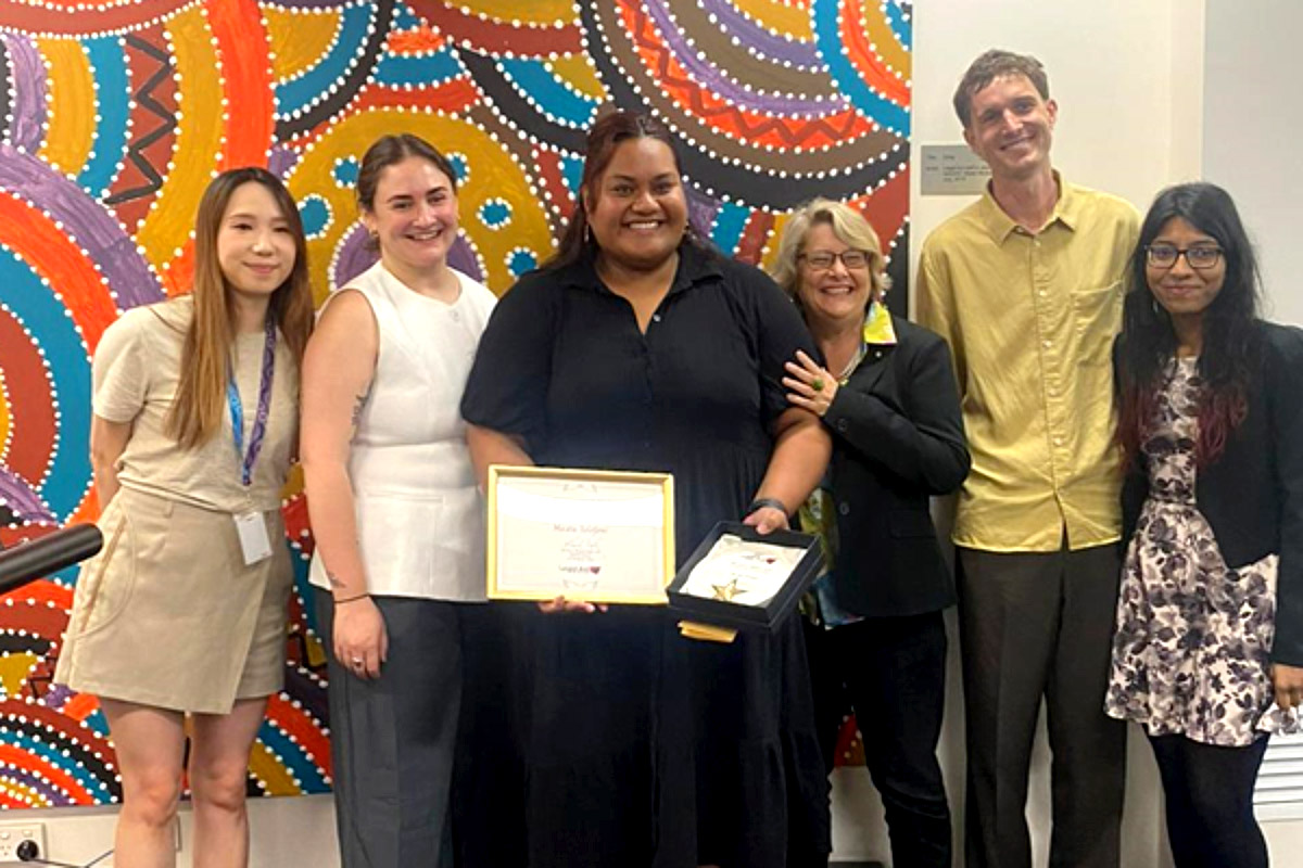 Ma'ata Solofoni (centre) holding her NSW Attorney General’s Award surrounded by her DRLS colleagues, left to right, Kirstern Lam, Amanda Bolin, Sally Bryant, Finn Hipkin and Nadia Mahmood.