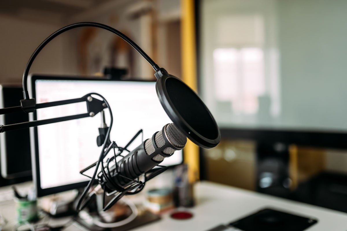 Podcast studio, featuring a microphone and computer.